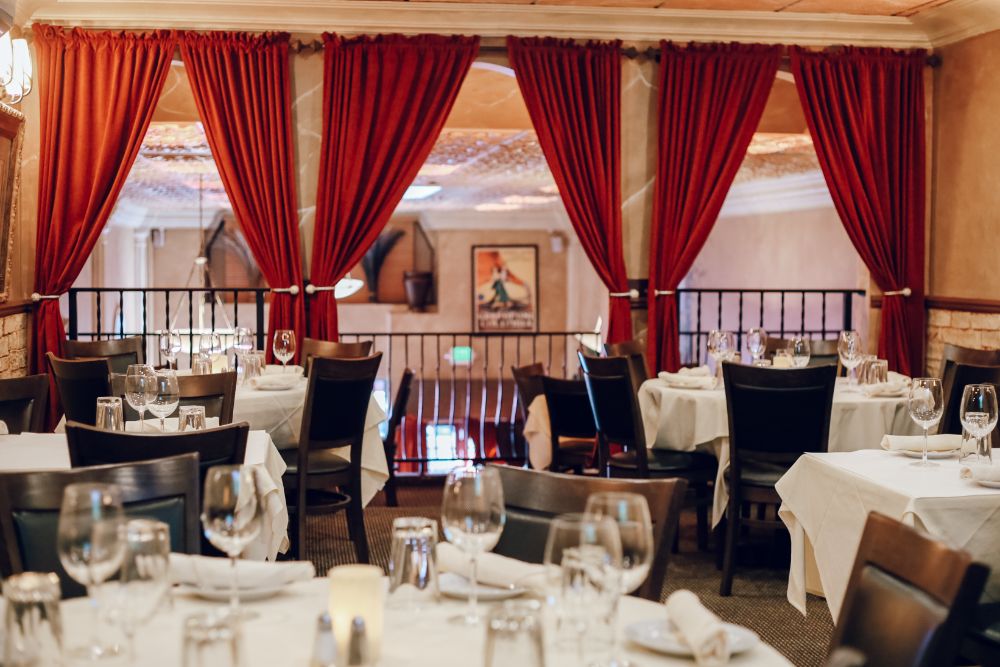 Dining room with red velvet curtains